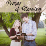 "Prayer of Blessing" with woman and man looking at Bible and smiling with big tree behind them
