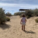 Girl walking through sand